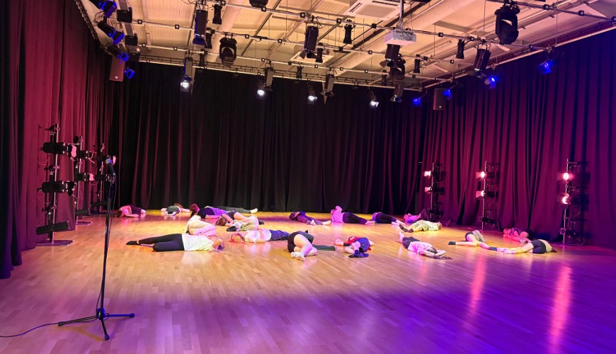 young people lying on the floor as part of a dance