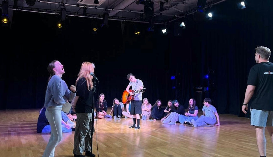 young people sat in a circle and laughing