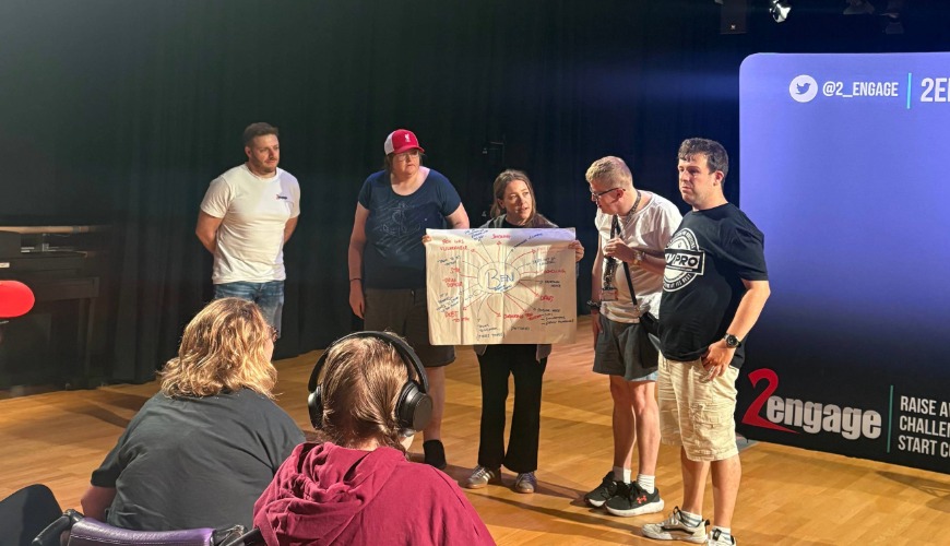 participants stood in a line presenting to an audience about their key takeaways from the risking it all show
