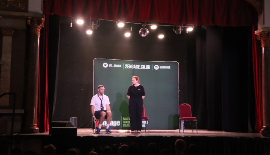 2 actors on stage performing the moving up show